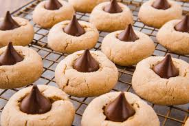 Rows of peanut butter blossom cookies cooling on a wire rack. Click for link to recipe.